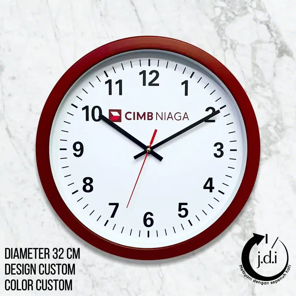 Jam dinding CIMB NIAGA 32 cm dengan desain custom, warna custom, dan logo j.d.i di sudut kanan bawah.